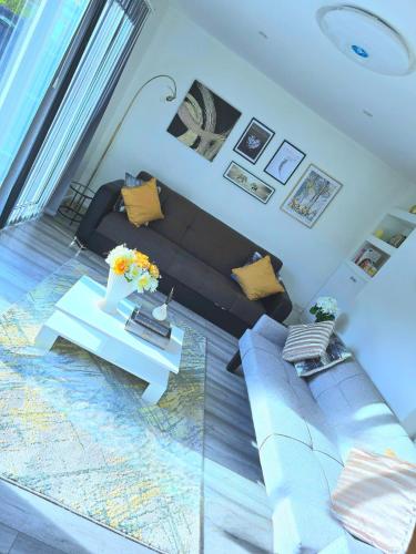 a living room with a couch and a table at Large House, Home for Contractors- Park Free in Chatham