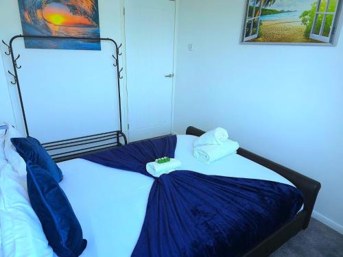 a bedroom with a bed with towels on it at Large House, Home for Contractors- Park Free in Chatham