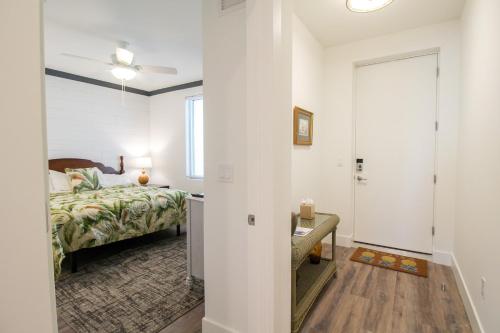 a bedroom with a bed and a door to a hallway at 1 BR Condo Downtown Sarasota - Close To Beaches in Sarasota