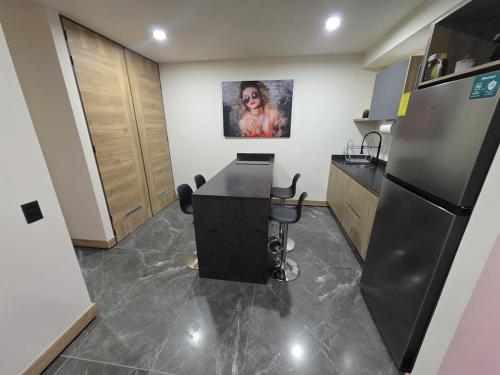 a kitchen with a desk and a refrigerator at Colonia Americana Apartment in Guadalajara