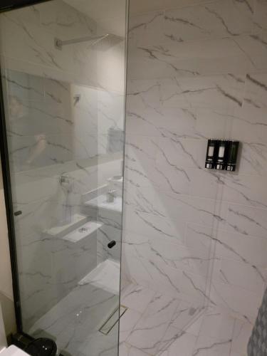 a bathroom with a shower with a glass door at Colonia Americana Apartment in Guadalajara