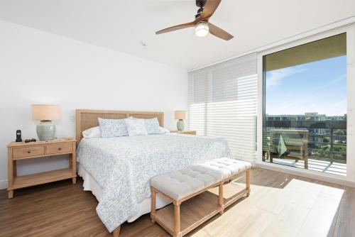 a bedroom with a bed and a large window at Charming 2 BR Longboat Key condo with ocean view in Longboat Key