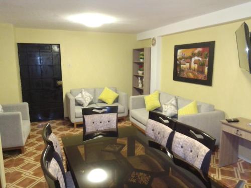 a living room with a couch and a table and chairs at Private Apartment in San Luis VIDENA in Lima