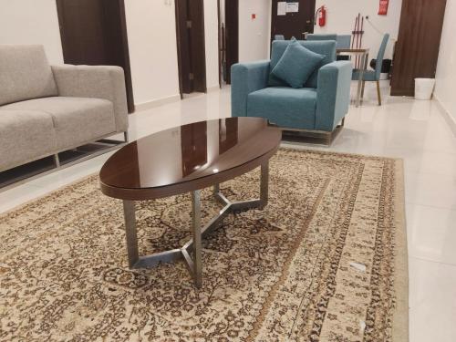 a living room with a coffee table and chairs at منتجع شاطئ الدولفين للإيواء السياحي in Yanbu