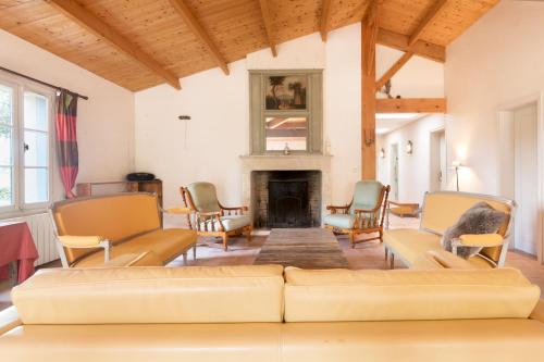 a living room with a couch and chairs and a fireplace at Le Marais Aixois - Grande maison familiale in Île dʼAix