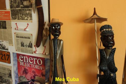 a couple of statues sitting next to a clock at Domek Podróżniczy in Łódź