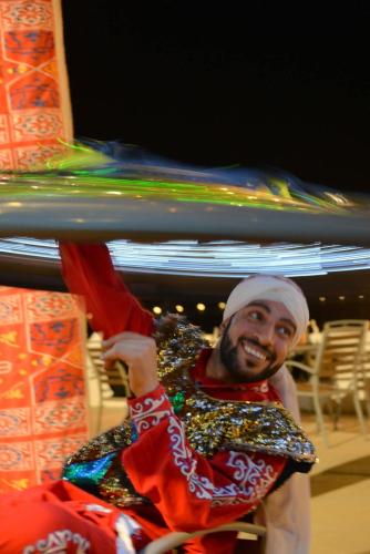a man is holding up a piece of cloth at منتجع شاطئ الدولفين للإيواء السياحي in Yanbu