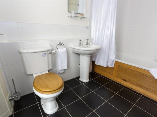 a bathroom with a toilet and a sink at The Golf Hotel in Silloth