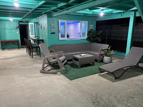 a living room with chairs and a couch and a table at Mami Ana Beach House, The Oceanfront Rest Hideaway ! in Ceiba