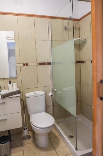 a bathroom with a toilet and a glass shower at Perla Paraisó in Playa Paraiso