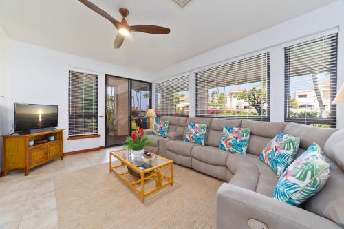 a living room with a couch and a flat screen tv at Shores at Waikoloa 132 Hale Kai in Waikoloa