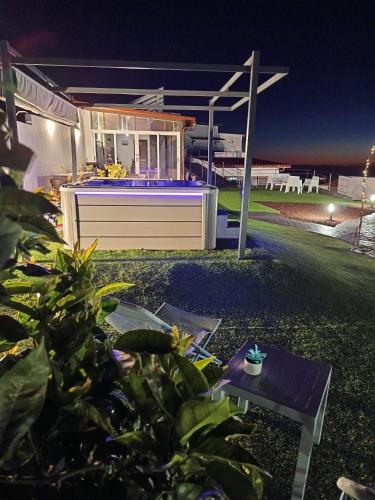 a backyard of a house at night with a hot tub at Casa Senderos del Norte in Sauzal