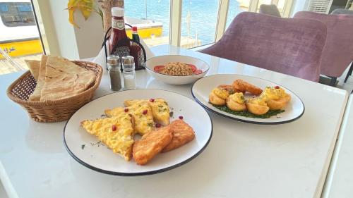 a table with three plates of food on it at منتجع شاطئ الدولفين للإيواء السياحي in Yanbu