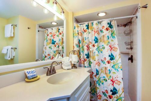 a bathroom with a sink and a shower curtain at Gorgeous Gulf views await you from this Sanibel Island condo - Loggerhead Cay #183 in Sanibel