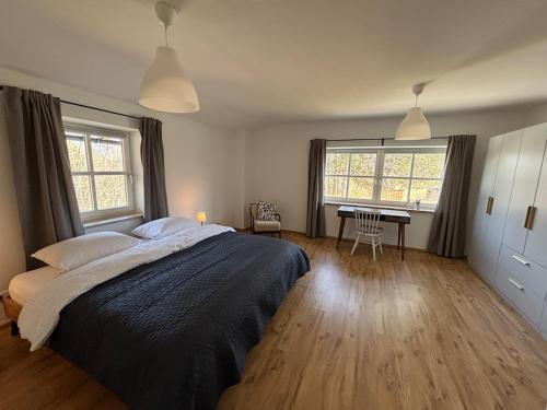 a bedroom with a bed and a desk in it at Rosenhäusl in Schönau am Königssee