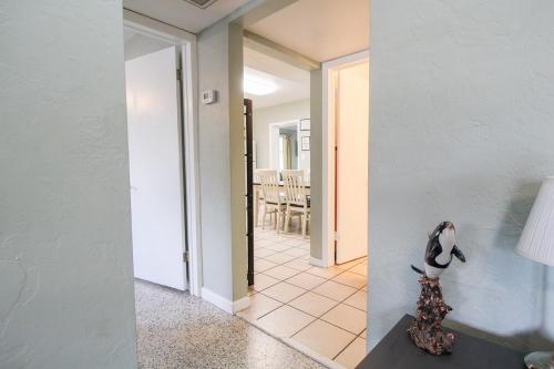 a room with a hallway with a penguin on a table at 2 BR Home With Private Beach Access To Golden Beach - Luna Sea in Venice