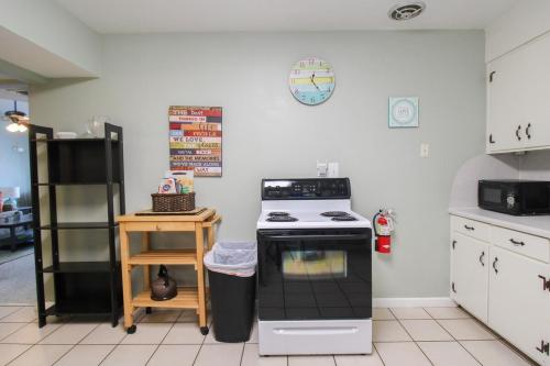 a kitchen with a stove and a black refrigerator at 2 BR Home With Private Beach Access To Golden Beach - Luna Sea in Venice