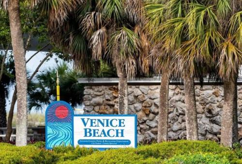 a sign for venice beach with palm trees at 2 BR Home With Private Beach Access To Golden Beach - Luna Sea in Venice