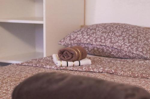 a rolled up towel on a bed with a pillow at Apartmani Matković in Žuljana