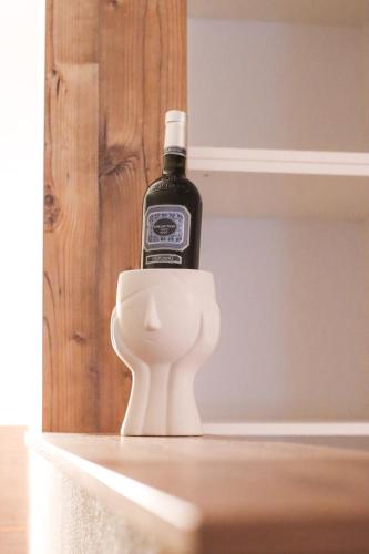 a bottle of wine sitting on top of a toilet at Apartmani Matković in Žuljana