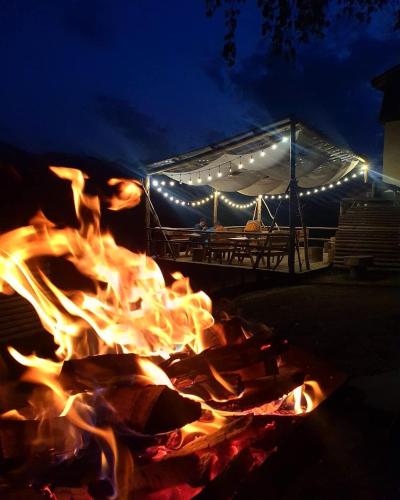 a fire pit at night with a stage in the background at House In The Mountains-Heshkili in Keshkili