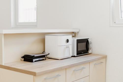a microwave sitting on top of a kitchen counter at Andrea Lux in Kotor
