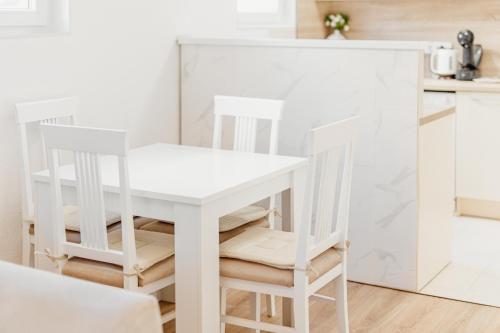 a white table and two chairs in a kitchen at Andrea Lux in Kotor