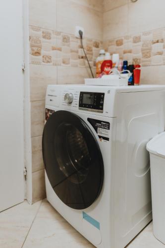 a white washing machine sitting in a room at Andrea Lux in Kotor
