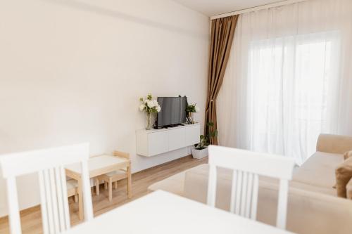 a white living room with a couch and a tv at Andrea Lux in Kotor
