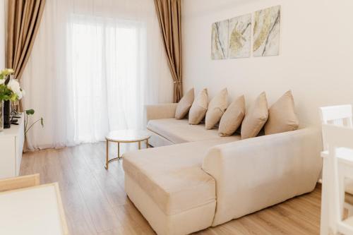 a white living room with a couch and a table at Andrea Lux in Kotor