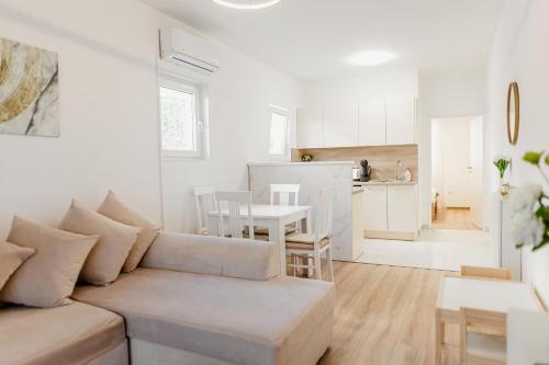 a white living room with a couch and a table at Andrea Lux in Kotor