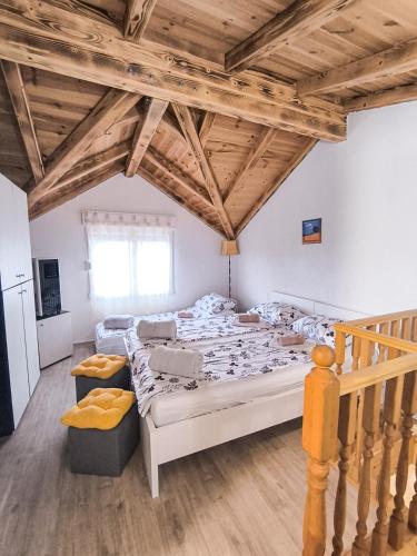 a large room with two beds and a staircase at Apartmani Matković in Žuljana