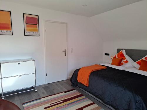 a bedroom with a bed and a cross on the wall at Zentral-Stilvoll-schöne Aussicht-Mediapaket-EN1 in Ennepetal