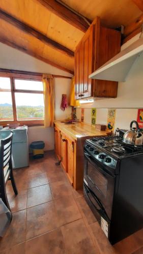 a kitchen with a stove and a counter top at Posada de montaña in Uspallata