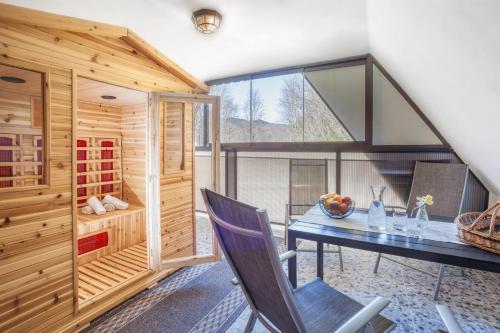 a dining room with a table and a window at Penzion Karolinka in Karolinka
