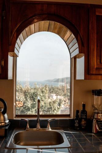 a kitchen sink with a window in the kitchen at Casa Salita in Sayulita