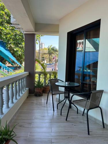a patio with a table and chairs on a balcony at Casa MIA in Cabarete