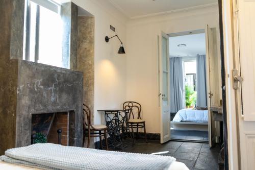 a room with a fireplace and a bedroom with a bed at Bellinzona Boutique in Buenos Aires