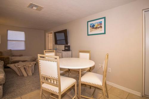 a living room with a table and chairs at Charming Manasota Key duplex with beach access- IB14 in Englewood