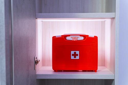 a red suitcase sitting on a shelf in a door at Ammiria in Cetara