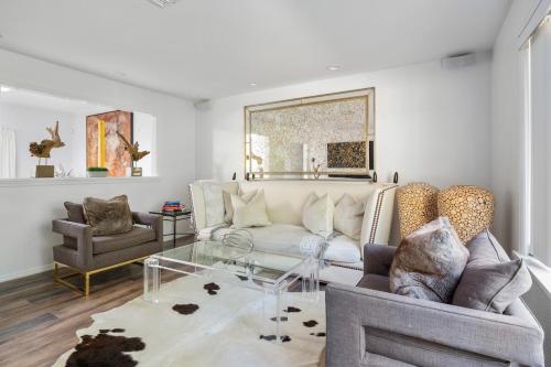 a living room with a couch and a glass table at Private completely fenced in property Near beach in Hampton Bays