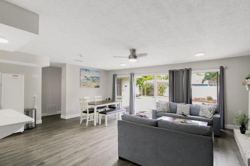 a living room with a couch and a table at Private pool home with game room - Shaker Of Salt in Sarasota