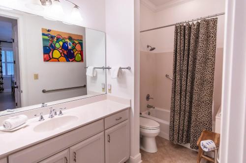 a bathroom with a sink and a toilet and a mirror at Journeys End 203 in Coffeyville