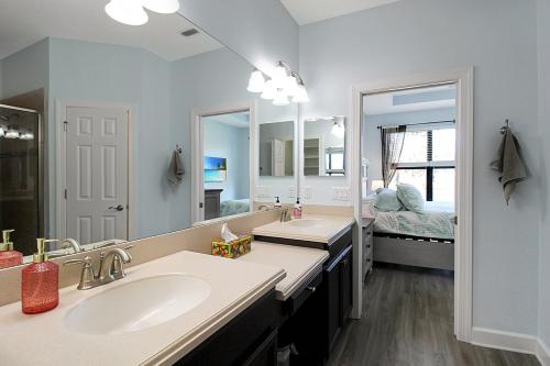 a bathroom with two sinks and a large mirror at Gorgeous lakefront home in Esplanade Golf & Country Club in Lakewood Ranch in Bradenton