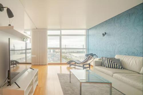 a living room with a couch and a table at Caravela - Torre Sao Rafael in Lisbon