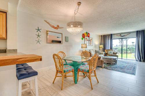 a dining room and living room with a table and chairs at Cape Canaveral Condo with On-Site Beach Access! in Cape Canaveral