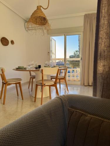 a living room with a table and chairs and a dining room at Luxury Holiday Townhouse with Pool II Casa Macarena 02 in Ciudad Quesada