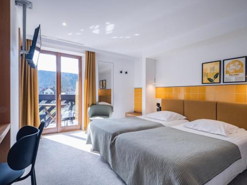 Postel nebo postele na pokoji v ubytování Hotel Au Vieux Moulin