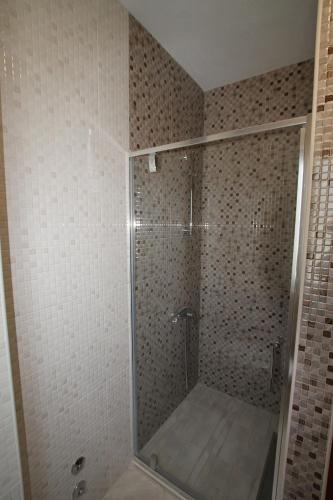 a shower with a glass door in a bathroom at Apartments Marovic in Herceg-Novi