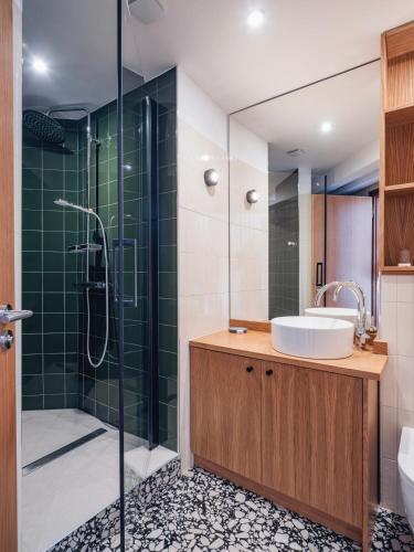 a bathroom with a sink and a shower at Hotel Au Vieux Moulin in Graufthal
